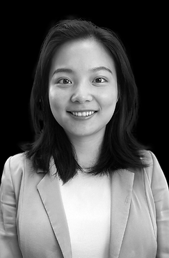 A black and white photo of a woman smiling.